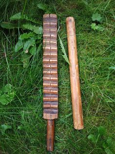 two pieces of wood laying on the grass