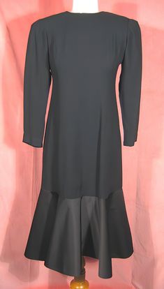 "Dramatic 70's cocktail dress in black crepe and satin by Estevez, who was the youngest designer to win the Coty award. Beautifully made, it's completely lined, and about a size 6. It measures approx. 14\" across slightly padded shoulders, up to 37\" bust, 20 1/2\" outside sleeve length, 28\" waist, 38\" hips, and 43\" overall length. It's in excellent, like new, condition. See my entire shop collection here https://www.etsy.com/shop/RobinClaytonVintage" Elegant Long Sleeve Vintage Evening Dress, Vintage Silk Midi Dress For Evening, Elegant Silk Vintage Dress For Party, Elegant Silk Vintage Party Dress, Vintage Long Sleeve Dress For Evening With Fitted Bodice, Vintage Long Sleeve Dress With Fitted Bodice For Evening, Evening Vintage Dress With Long Sleeves And Fitted Bodice, Long Sleeve Vintage Dress With Fitted Bodice For Evening, Black A-line Vintage Dress For Evening