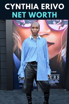 a woman standing in front of a movie poster