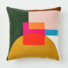 a pillow with an abstract design on the front and back, sitting on a white surface