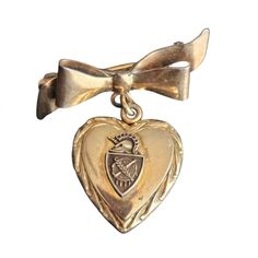 Vintage Gold Military Heart Locket on Bow  Brooch Pin 1/20 10K Gold on Sterling Silver Double photo locket Hinge and snap closure Functional and ready to wear Normal wear for vintage piece Approx. Measurements: Length- 1.5" 10K Gold, sterling sliver, military, cadet, vintage, locket Vintage Medallion Brooch For Wedding, Vintage Medallion Brooches For Wedding, Antique Brooches With Vintage Charm As Gift, Antique Brooches With Vintage Charm For Gifts, Gold Brooches With Vintage Charm For Gift, Gold Brooches With Vintage Charm As Gift, Vintage Memorial Brooch Jewelry, Antique Heart Brooch For Wedding, Vintage Wedding Brooches For Valentine's Day