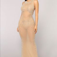 a woman in a nude colored dress with sequins on the back and sides