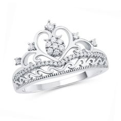 Treat her like royalty with this shimmering diamond ring. Crafted in cool 10K white gold, this beautifully detailed design features a round diamond composite at its center, diamond accents and a diamond chevron ribbon. Scrolling details create the heart-shaped crown and band. Captivating with 1/5 ct. t.w. of diamonds and a brilliant buffed luster, this crown ring reminds her of your love. Dainty Diamond Band, Crown Rings, Symbol Jewelry, Tiara Ring, Heart Crown, Sapphire Wedding Band, Diamond Tiara, Green Stone Rings, Princess Ring