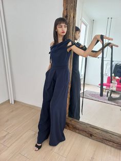 Our Dark Blue jumpsuit with Asymmetrical Neckline is made of: ℘ Carefully chosen fabrics, finest quality and perfect finishes  In the delicate but impressive details you can feel the love we have been working with! So when wearing this garment always have in mind how special and important person YOU are!   ℘ Sizes: From XS to XL - check out the size chart in the last picture   ℘ Custom fit: Your comfort in essential to us, so we can make the garment specially with your measurements. Please, make sure to write us    ℘ Care: * Hand Wash 30 ͦ degree * Machine Wash 30 ͦ degree    ℘ Delivery: The standard shipping takes: US & Canada: 10-15 biz days; Europe: 7-14 biz days; Everywhere Else: 10-15 biz days   ℘ Find more minimalist and authentic designs here: https://www.etsy.com/shop/LeBrandStudio Elegant One-shoulder Blue Jumpsuits And Rompers, Elegant Blue One-shoulder Jumpsuit, Chic Navy Sleeveless Jumpsuits And Rompers, Navy Sleeveless Fitted Jumpsuits And Rompers, Chic Blue One-shoulder Jumpsuit, Dark Blue Jumpsuit, Jumpsuit Formal, Navy Blue Jumpsuit, Jumpsuit Navy Blue