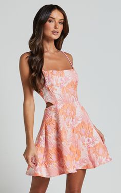 Get ready to turn heads in the Lauraine Mini Dress! This stunning pink and orange floral dress features a strappy straight neck and a flattering fit & flare silhouette. Made from high-quality jacquard polyester, this sleeveless mini dress is perfect for any party or day out. The back cut-out adds a touch of sophistication to this already chic ensemble. Embrace your feminine side with confidence and style in the Lauraine Mini Dress - because you deserve to feel amazing, no matter the occasion! Pr Pink And Orange Floral Dress, Orange Hoco Dress, Floral Hoco Dress, Semi Ideas, Unique Hoco Dresses, Pink And Orange Dress, Fancy Clothing, Paris April, Hoco Dresses Pink