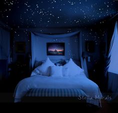 a bed in a room with stars on the ceiling