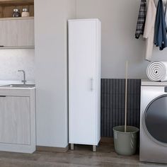 a laundry room with washer, dryer and cabinets