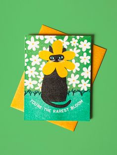 two greeting cards with an image of a black cat and daisies on them, one says you're the rarest bloom