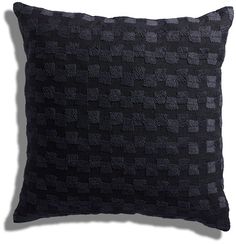 a black pillow on a white background that is made out of squares and rectangles