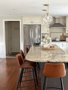 a large kitchen island with chairs around it