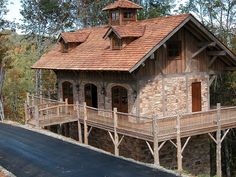 a wooden house sitting on the side of a road