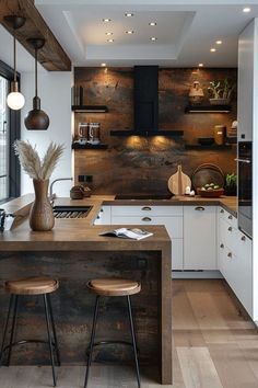 a kitchen with an island and stools next to the counter top in front of a window