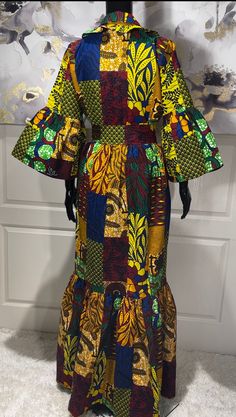 The KEMI African Print Maxi Dress is the perfect dress for any occassion, including holiday parties. A beautiful Ankara patchwork print dress that will make you look stunning. Be ready for all the compliments!  Look Unique. Know You Are Beautiful. Available in sizes S-2XL Yellow, Maroon, Blue, Green, And Black In Color Ankara Patchwork Print  Tiered Dress Ruffled Shirt Colar Ruffled Sleeves  Ruffled Hem Cloth Belt CARE Hand Wash Or Machine Wash On Cool Gentle Cycle. Line Dry, Steam Iron. Fitted Green Maxi Dress For Holiday, Fitted Patchwork Maxi Dress, Multicolor Patchwork Dress For Party, Fitted Midi Dress With Patchwork, Fitted Green Maxi Dress With Patchwork, Multicolor Patchwork Party Dress, Bohemian Patchwork Party Dresses, Traditional Fitted Midi Dress For Party, Yellow Patchwork Maxi Dress