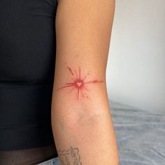 a woman's arm with a red ink splattered on the back of it