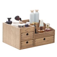 an open wooden drawer with cosmetics and lotion in it