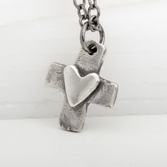 Express your faith and love with this cute handmade 925 sterling silver cross necklace featuring an original and unique design. Its highly polished heart on a vintage patina style cross adds a beautiful, meaningful touch. Perfect for a young girl's Confirmation, First Communion, or a special Valentine's or Christmas gift! The pendant hangs on a lovely 925 sterling silver chain. Gift Sterling Silver Cross Necklace With Oxidized Finish, Gift Cross Necklace With Oxidized Finish, Gift Oxidized Cross Pendant Necklace, Oxidized Cross Pendant Necklace For Gift, Oxidized Cross Necklace As Gift, Oxidized Finish Cross Necklace As Gift, Oxidized Finish Cross Necklace For Gifts, Heart And Cross, Patina Style