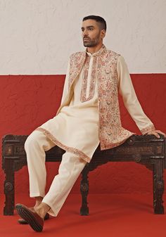 Elevate your elegance with Cream Jacket Kurta. Crafted from luxurious georgette, the jacket boasts intricate resham, zari, and sequin embroidery. The kurta features a yoke design, two pockets, and pure lining for ultimate comfort. Complete the look with matching pants for a sophisticated ensemble. Perfect for special occasions like Sangeet, Mehendi, Haldi, or as a wedding guest outfit. Composition : Jacket, Kurta & Trouser : Viscose Georgette Care: Dry Clean Only and Vacuum Storage This product Kurta Set With Jacket, Kurta With Jacket, Yoke Design, Outfit Wedding, Vacuum Storage, Cream Jacket, Indian Wedding Wear, Sequin Embroidery, Matching Pants