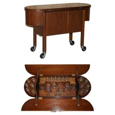 an old fashioned wooden desk with wheels and knobs