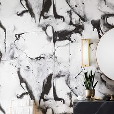 a black and white wall with gold accents