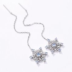 Celebrate this Christmas with our Romantic Snowflake Silver Long Earrings carefully crafted with sterling silver and framed with delicate blue stones, sparkling brightly like a fallen snow. This chic accessory is suitable for daily wear and will infuse elegance and into your style. A lovely gift for women. Item specifics: Style Romantic Earrings Pendant Size Earring Size:17.5*17.5MM(0.68*0.68INCH), Stone1 Size: 2.5MM(0.098INCH), Stone2 Size: 2.0MM(0.078INCH) , Length of earrings: 50MM(2INCH) Thi Silver Long Earrings, Romantic Earrings, Family Tree Necklace, Snowflake Earrings, Blue Stones, Earrings Pendant, Christmas Charms, Cz Jewelry, Birthstone Earring