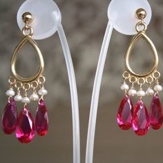 "These elegant dangling ruby zirkon earring inspired by Bukharian style earrings, are one of 'Silk Trail Jewelry's' first collection.  My origins are from the magical city - Samarkand.  My jewelry's are influence by the atmosphere and inspired by the patterns, colors and textures that characterize the Silk Road countries: Central Asia, India, China, Persia and more. The creation of this jewelry made me feel the magical journey to my roots through my fingers. Thanks to the combination of seed pea Elegant Ruby Chandelier Earrings For Festive Occasions, Elegant Red Danglers, Elegant Pink Dangling Beads Earrings, Elegant Pink Chandelier Earrings With Dangling Beads, Elegant Red Chandelier Earrings With Dangling Beads, Elegant Ruby Chandelier Dangle Earrings, Ruby Drop Chandelier Earrings As Gift, Elegant Teardrop Chandelier Earrings With Latkans, Elegant Ruby Danglers For Celebration