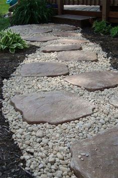 a garden path made out of rocks and gravel