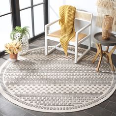 a white chair sitting on top of a rug