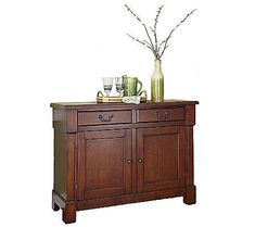 a wooden cabinet with two vases on top