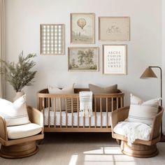 a baby's room with a crib, rocking chair and pictures on the wall