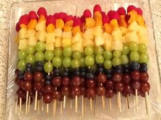 fruit skewers are arranged in rainbow colors