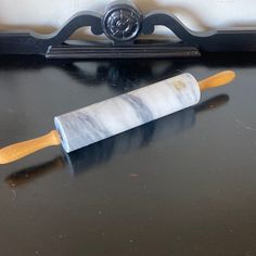 a marbled rolling pin sitting on top of a black counter