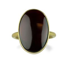 A regal beauty, this Gabriella Kiss ring features a bezel set, oval almandine garnet. Crafted in brushed 18k yellow gold, this devastatingly dark red ring echoes the deepest desires of the heart. Stone measures 3/4” x 5/8”. Size 7. Handcrafted in Hudson Valley, NY, U.S. Gabriella Kiss, Hudson Valley Ny, Red Ring, Red Rings, Almandine Garnet, Heart Stone, Garnet Ring, 18k Yellow Gold Ring, Garnet Rings