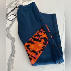 Brand New With Tags. 100% Authentic Mcm Side Snap Button Track Pants Size Xsmall Color - Navy Blue With Multicolor Insert Features Elasticized Waistband Pull-On Side Snap Button Plackets Side Slip Pockets Back Welt Pockets Geometric Print Panel 100% Cotton Hand Wash Made In Italy Measurements Rise, About 11" Inseam, About 29" Leg Opening, About 16" Comes Exactly As Shown In Photos. Blue Bottoms With Buttons For Loungewear, Orange Logo, Side Snap, Classic Logo, Jogger Sweatpants, Side Stripe, Green Cotton, Welt Pockets, Winter Women