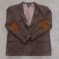 The Uniform Of Generations Of Prep And Ivy League Students And Teachers. Herringbone And Windowpane Wool Tweed. Brown/Olive/Tan/Azure. Suede Elbow Patch. Classic Woven Leather Buttons. Throat Latch Tab Closure. Norfolk Style Half Belt And Swing Action Pleats. Single Vent. Three Button/Roll Two Lapels. Men's Classic Fit Xl Will Fit 44, 46, And 48 Depending On Layering. New, Unworn Condition. A Piece Of History No Longer Available. Tweed Coat Mens, Fitted Brown Tweed Jacket With Patch Pockets, Brown Tweed Suit, Olive Tan, Brown Tweed, Ivy League Style, Tweed Coat, Tweed Suits, Tweed Blazer