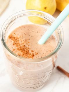 a smoothie in a mason jar with a blue straw