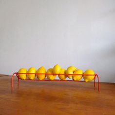 a group of lemons sitting on top of a wooden table