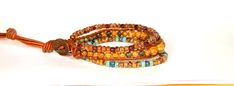 the beaded bracelets are made with glass beads and leather cord, which is attached to an orange string