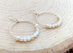 Gorgeous boho gold hoop earrings in moonstone peach color crystal. Gold plated or gold filled sterling silver hooks makes it hypoallergenic Comfortable and light for everyday wear. Materials: Gold plated hoops w/ gold plated hooks Gold filled hoops w/ gold filled hooks Hoops size: Medium 30mm Large 40mm Simple yet elegant especially the shine and color are so gorgeous.The picture does not do it justice it and is much prettier in person. Perfect for birthday, Christmas, mother's day, bridesmaid g Handmade Delicate Hoop Earrings, Delicate Handmade Round Hoop Earrings, Handmade Delicate Round Hoop Earrings, Gold Wire Wrapped Hoop Earrings For Summer, Summer Gold Wire Wrapped Hoop Earrings, Raw Stone Earring, Boho Hoop Earrings, Earrings Gold Hoop, Gold Filled Hoops