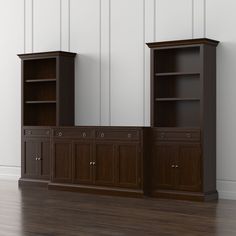 two wooden bookshelves sitting next to each other on top of a hard wood floor