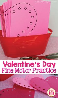 valentine's day fine motor practice with pink paper in a red bucket and scissors