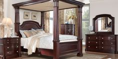 a bedroom with a canopy bed, dresser and mirror