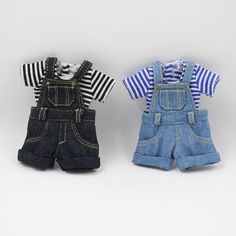 two dolls are dressed in denim overalls and striped t - shirt, one is black and the other is blue