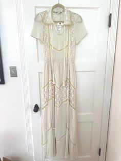 Very pretty ivory lace gown with dainty pleats. It's a modern dress but is inspired by vintage prairie dresses. Would be perfect for a more casual wedding dress. This has never been worn but has a small stain on the chest. Most likely would be very easy to get out - I have not tried to clean it. Size small. Spring Cream Dress With Delicate Lace, Cream Maxi Dress With Lace Patchwork, Cream Lace Midi Maxi Dress, Flowy Cream Dress With Lace Patchwork, Cream Dresses With Lace Patchwork Flowy Fit, Cream Flowy Dress With Lace Patchwork, Cream Lace Trim Maxi Dress For Wedding, Flowy Cream Dress With Lace Trim, Cream Maxi Dress With Lace Trim