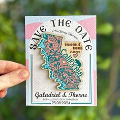 someone holding up a save the date magnet