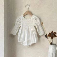 Casual Bubble Romper With Smocked Back For Spring, Casual Spring Bubble Romper With Smocked Back, Cute Long Sleeve Summer Onesie, White Long Sleeve Bubble Romper For Loungewear, Cute Spring Cotton Bodysuit, White Cotton Bubble Romper For Loungewear, Casual Long Sleeve Bubble Romper For Spring, Spring Long Sleeve Ruffled Onesie, Spring Casual Long Sleeve Bubble Romper