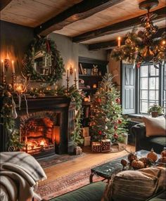 a living room decorated for christmas with candles and garlands on the fireplace mantel