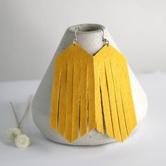 "Yellow Suede Earrings, Leather Earrings, Fringe Earrings, Daffodil Earrings, Womens Earrings, Boho, Boho Suede, Southwest Earrings Trendy and gorgeous this pair of golden suede leather earrings is feminine and stylish and a pair of earrings that will soon become a new favorite! The color is more of a golden yellow than bright yellow! Featuring.. 3 1/4\" drop from the top of the ear wire, 1 1/4\" wide Stainless Steel ear wires Your beautiful new earrings come in a gift box with a ribbon too! Perfect for gift giving! Thanks for stopping by!" Faux Suede Earrings, Yellow Leather Jewelry For Gifts, Gold Leather Earrings For Gift, Elegant Yellow Tassel Earrings, Yellow Bohemian Metal Earrings, Sunflower Ring, Feather Ring, Personalized Rings, Wedding Jewelry Earrings