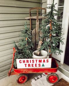 a red wagon with christmas trees in it