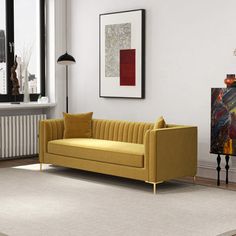 a living room scene with focus on the couch and chair, as well as an art piece