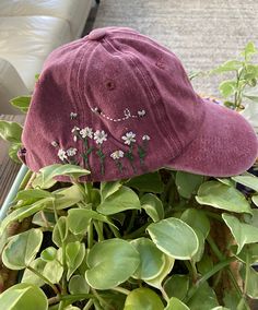 a purple hat sitting on top of a green plant